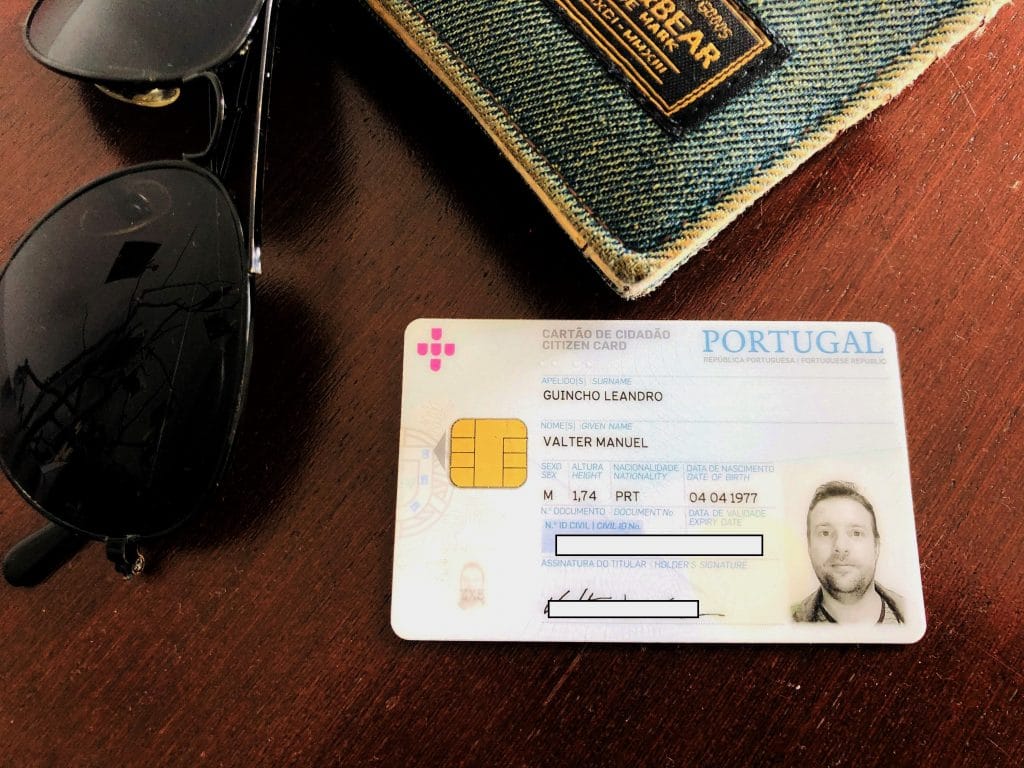 cartão cidadão sobre uma mesa com um óculos e um caderno próximos