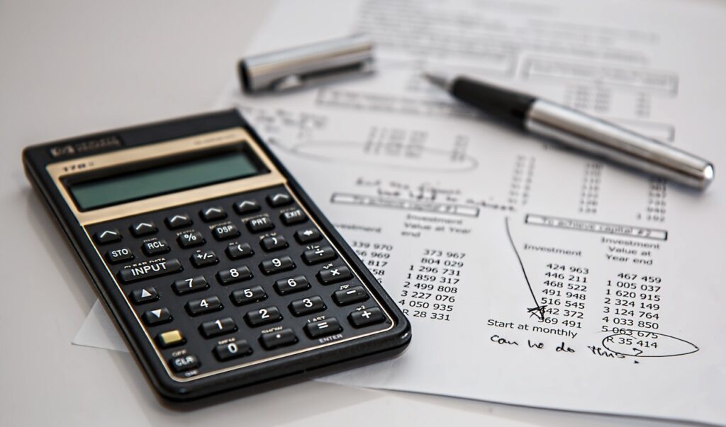 imagem com um papel com diversas taxas e uma calculadora que a pessoa pode calcular a diferença entre o depósito a prazo simples e estruturado