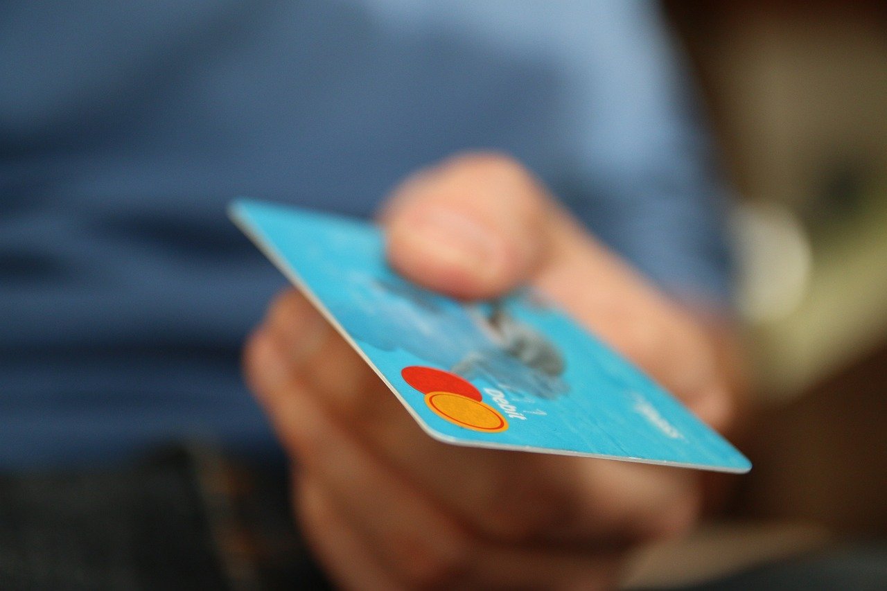 Mão entregando cartão verde Mastercard